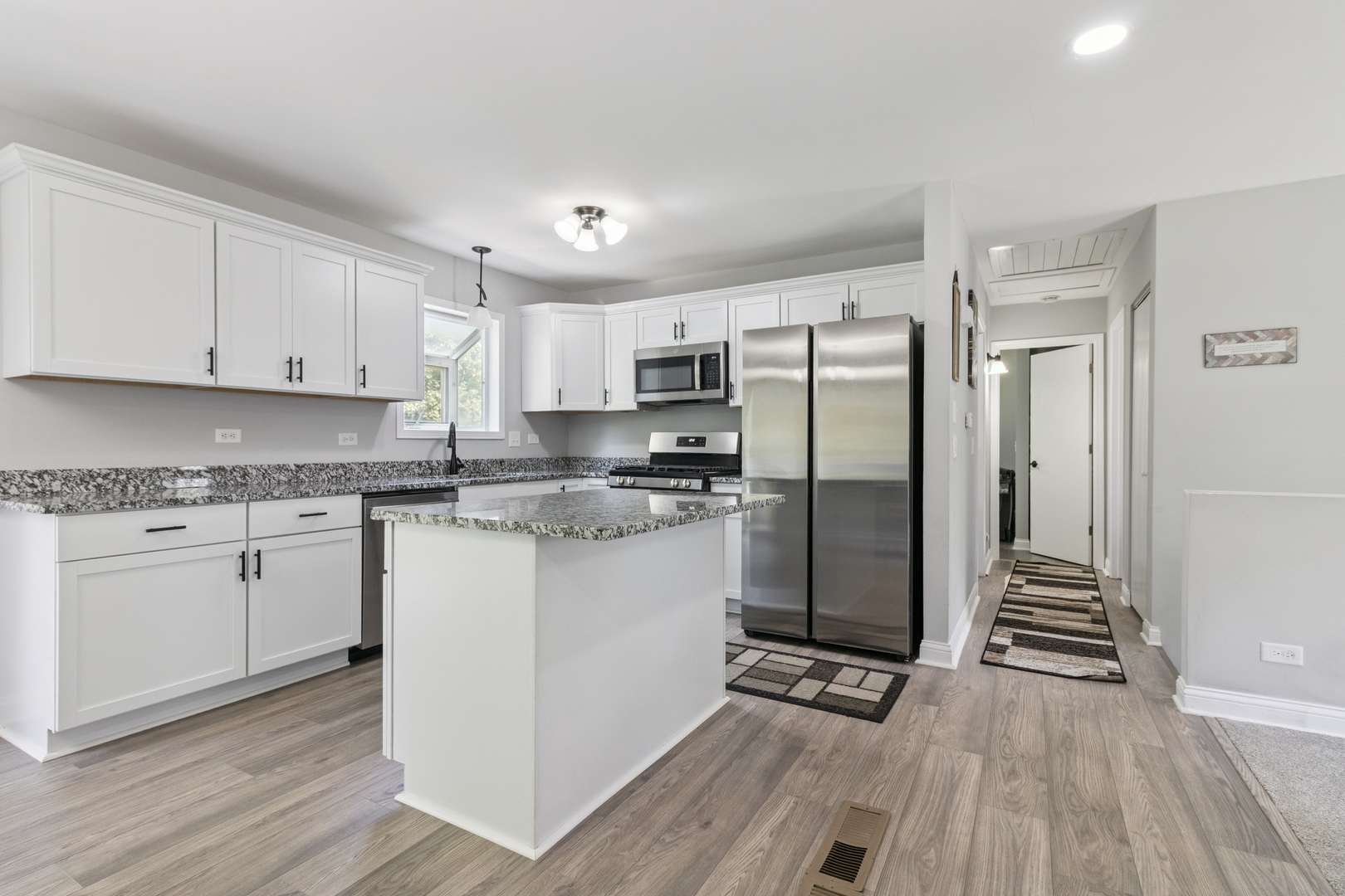 1243 Jericho Road Aurora, IL 60506 - Photo 9 of 25 a kitchen with granite countertop a refrigerator oven a sink and white cabinets