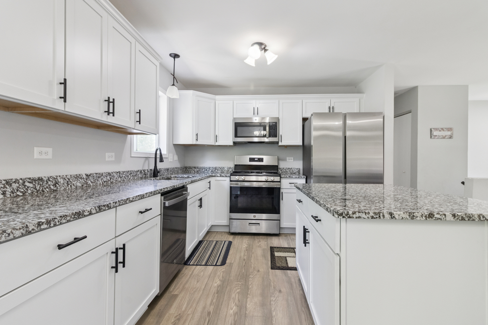 1243 Jericho Road Aurora, IL 60506 - Photo 10 of 25 a kitchen with stainless steel appliances granite countertop a stove a sink and a refrigerator