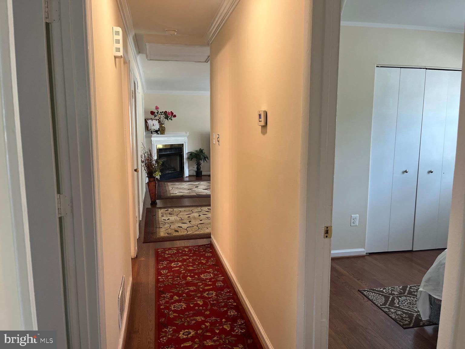 13629 Kingsman Road Woodbridge, VA 22193 - Photo 16 of 43 a view of a hallway with wooden floor and a bathroom