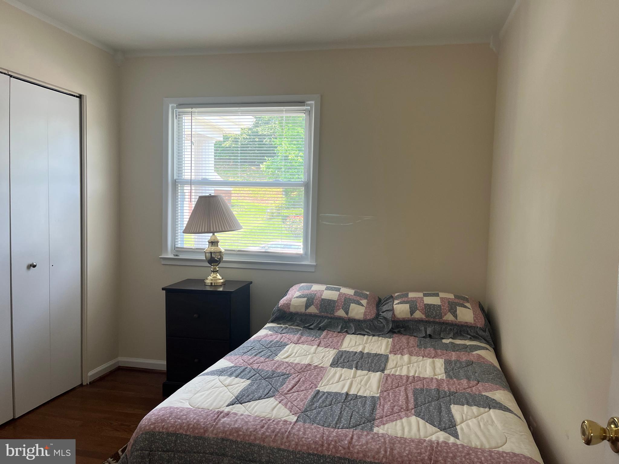 13629 Kingsman Road Woodbridge, VA 22193 - Photo 24 of 43 a bedroom with a bed window and a table