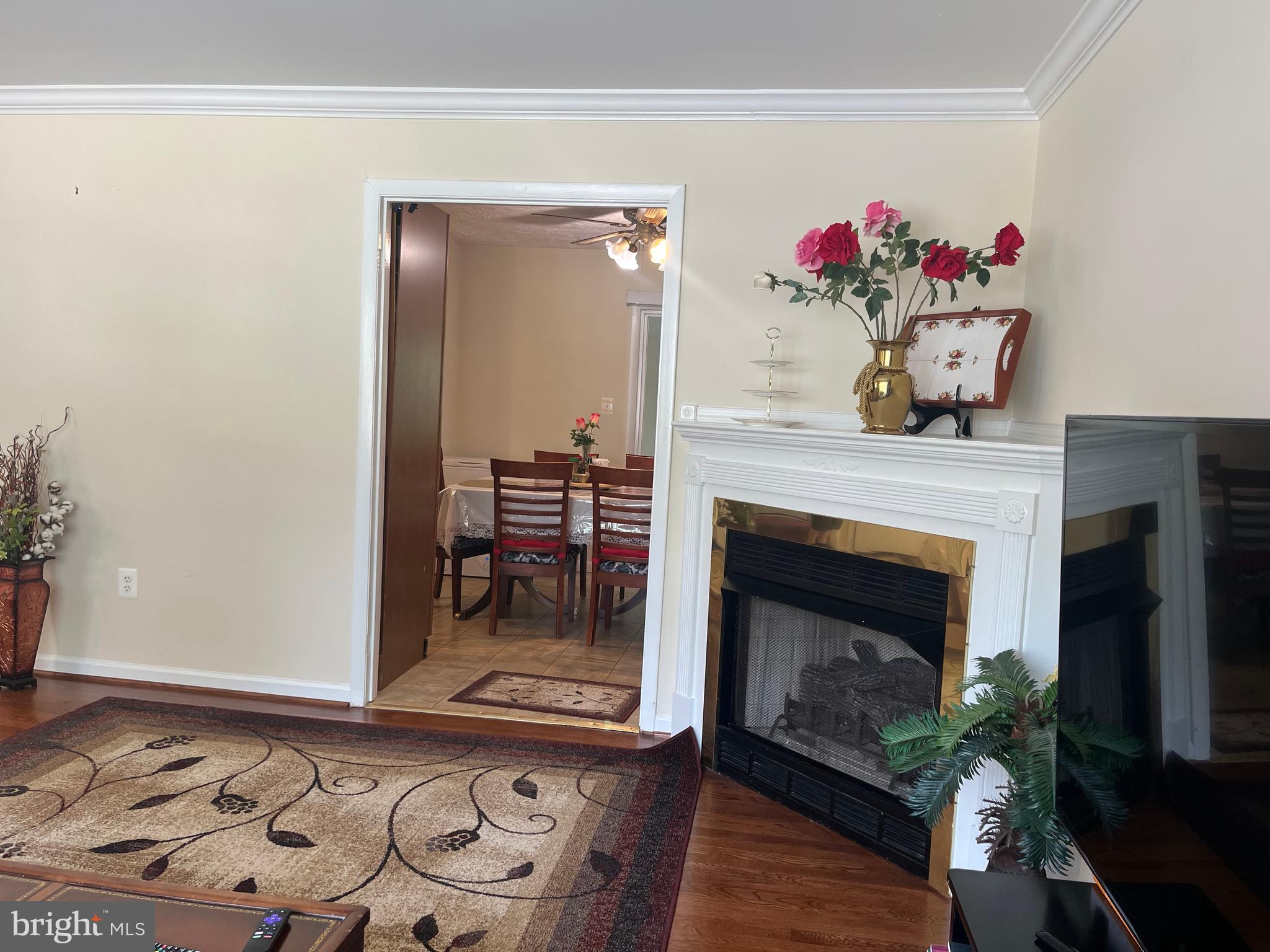 13629 Kingsman Road Woodbridge, VA 22193 - Photo 6 of 43 a living room with a fireplace and wooden floor