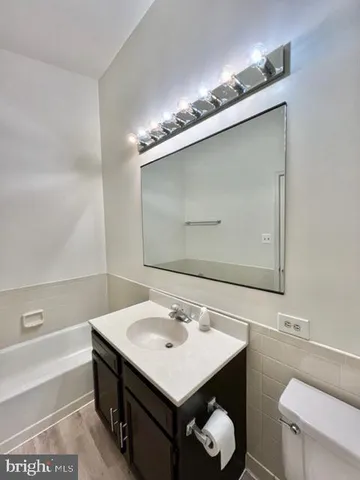 a bathroom with a sink vanity and toilet