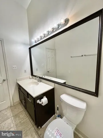 a bathroom with a sink a toilet and mirror