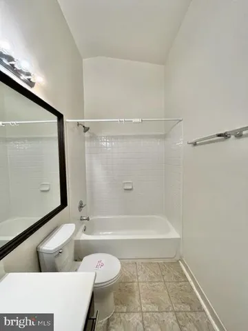 a bathroom with a shower a toilet and a bathtub