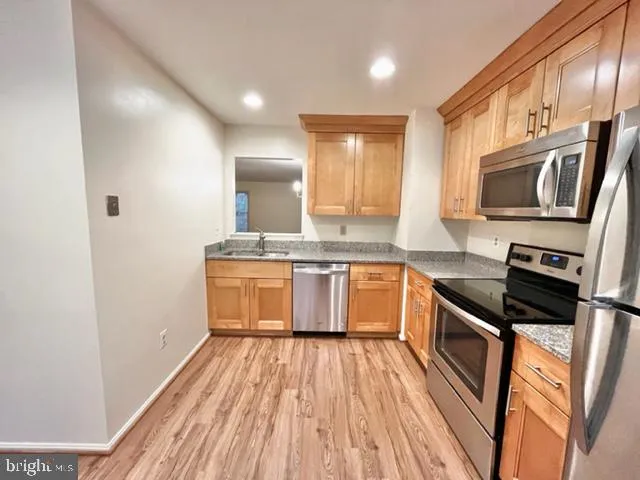 a kitchen with a sink stove top oven and microwave