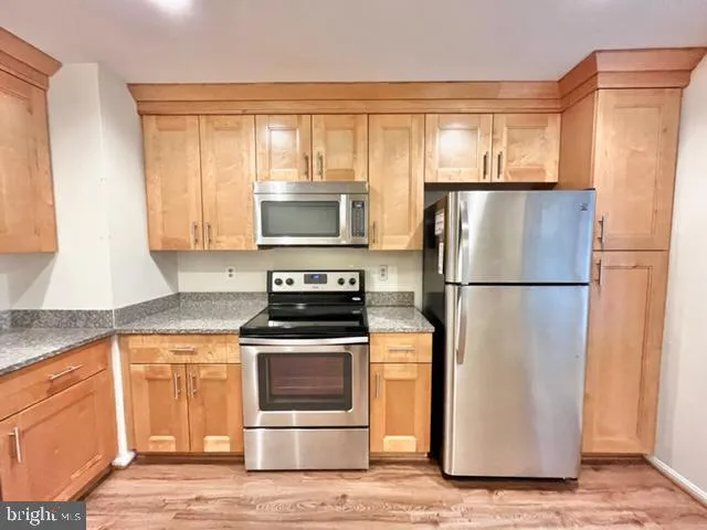 a kitchen with a refrigerator stove and microwave
