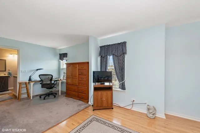 a bedroom with furniture and wooden floor