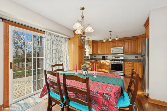 a view of a dining room with furniture and a chandelier