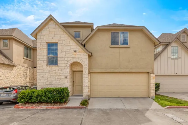 a front view of a house with garage