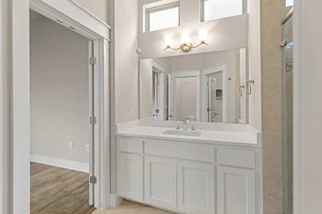 a bathroom with a sink vanity and a mirror