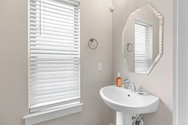 a bathroom with a sink and a window