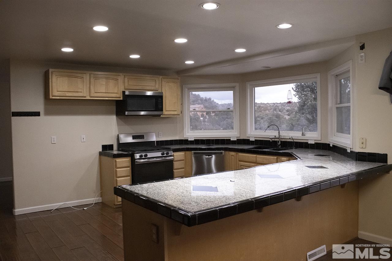 1685 Lousetown Road Reno, NV 89521 - Photo 8 of 28 a kitchen with a stove and a sink