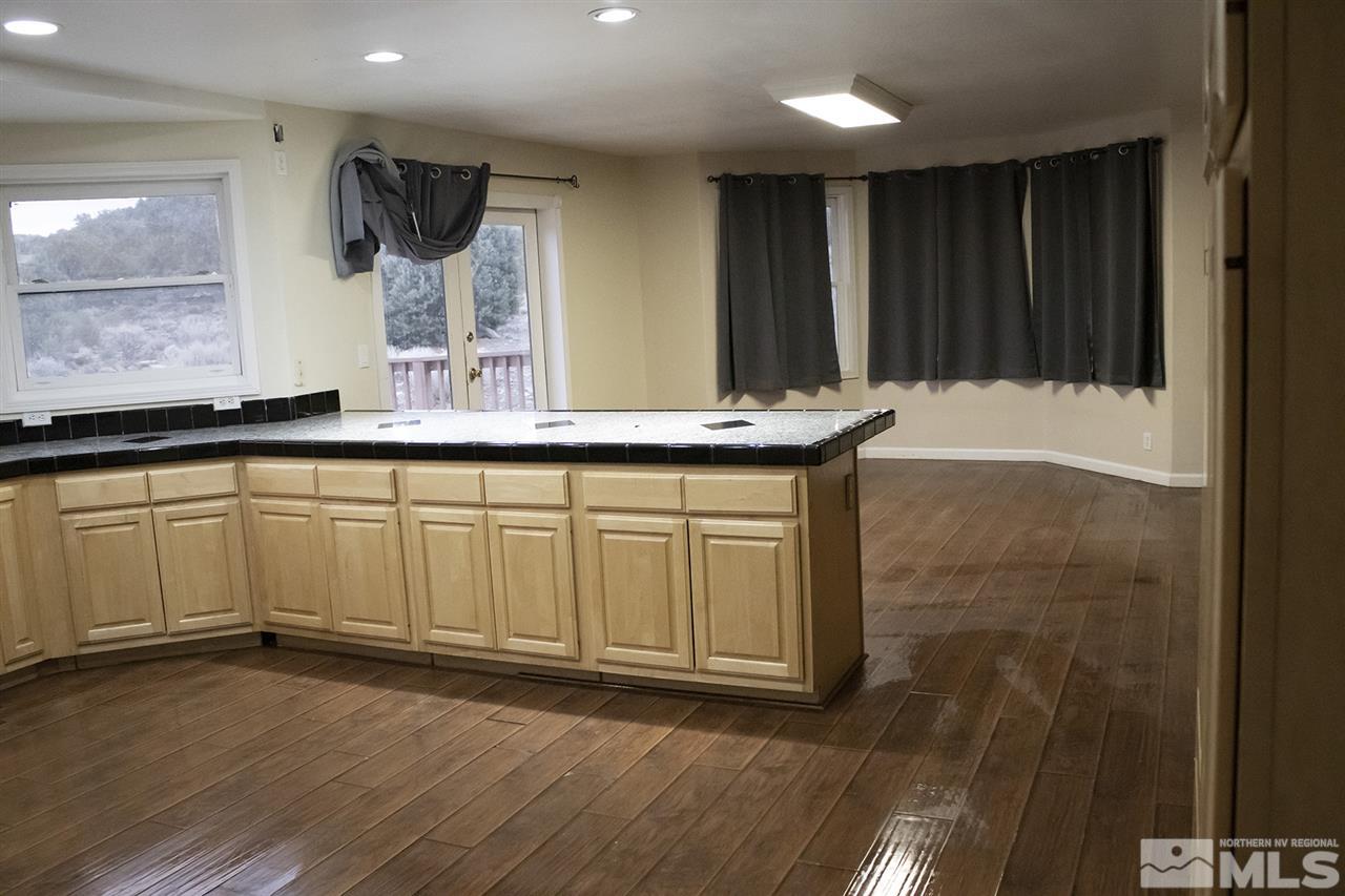 1685 Lousetown Road Reno, NV 89521 - Photo 9 of 28 a view of a kitchen with a sink and wooden floor