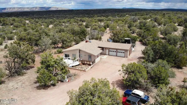 an aerial view of a house with a yard