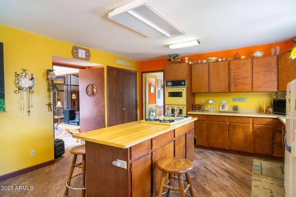a kitchen with stainless steel appliances granite countertop a sink and a refrigerator
