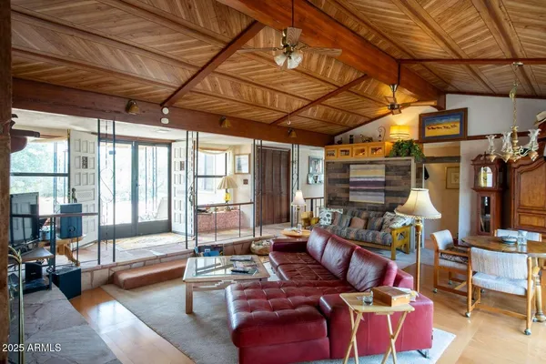 a living room with furniture and a chandelier