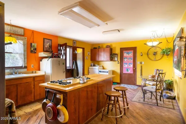 a room with stainless steel appliances kitchen island granite countertop furniture and a large window