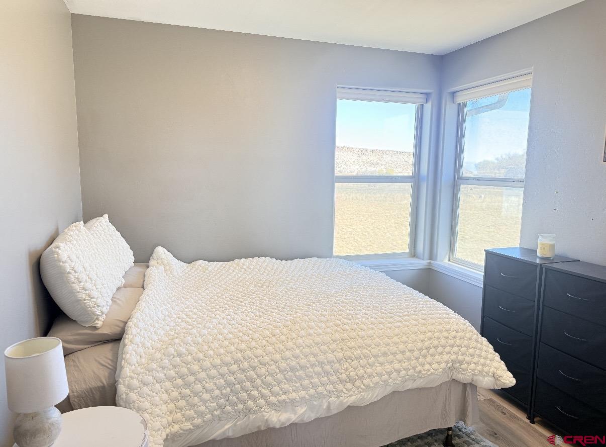 15807 5790th Road Montrose, CO 81403 - Photo 11 of 30 a bedroom with a bed and wooden floor