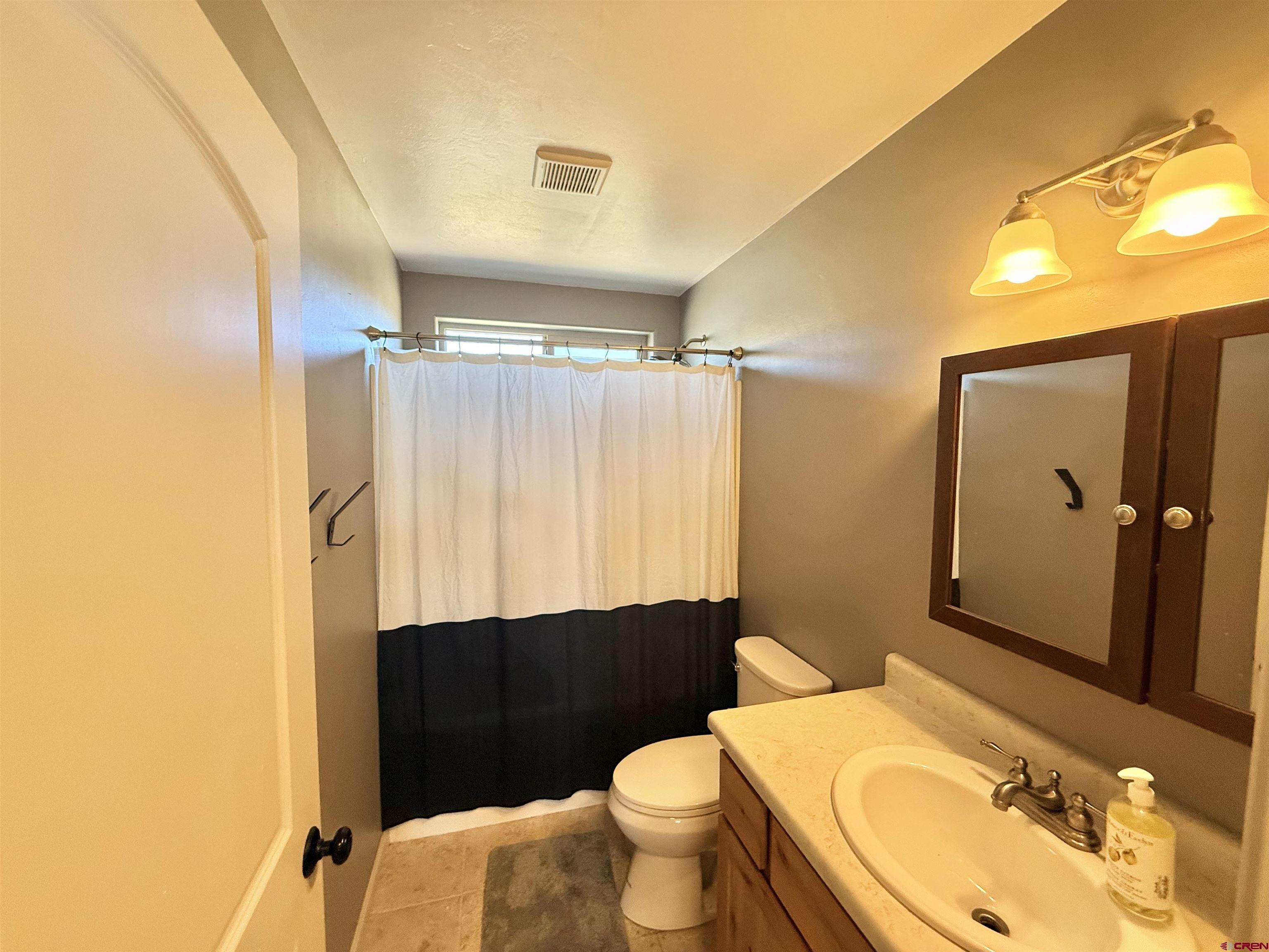15807 5790th Road Montrose, CO 81403 - Photo 14 of 30 a bathroom with a sink vanity mirror and toilet