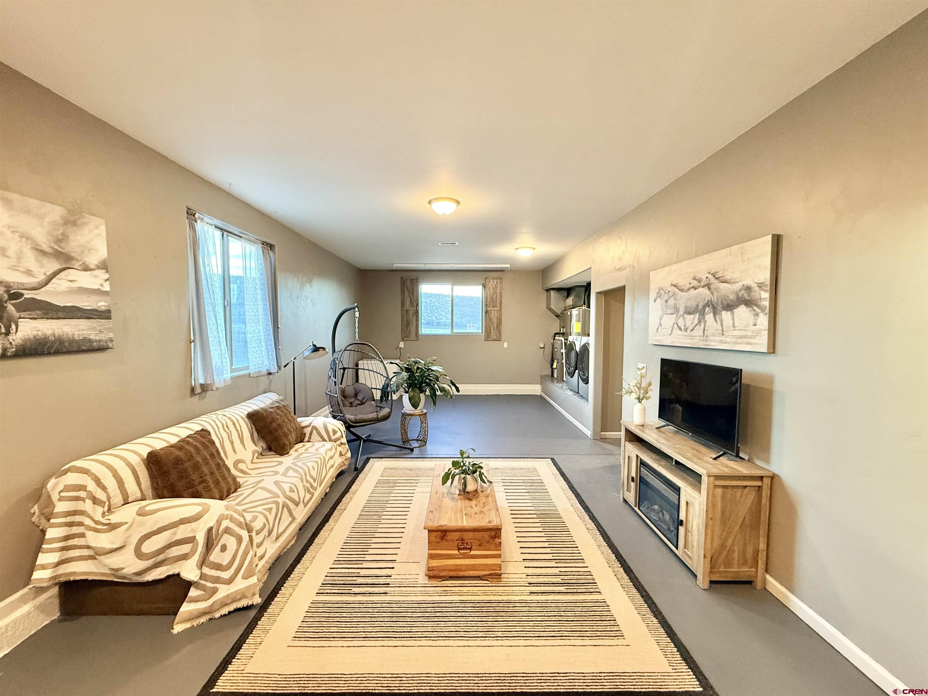 15807 5790th Road Montrose, CO 81403 - Photo 17 of 30 a living room with furniture and a flat screen tv
