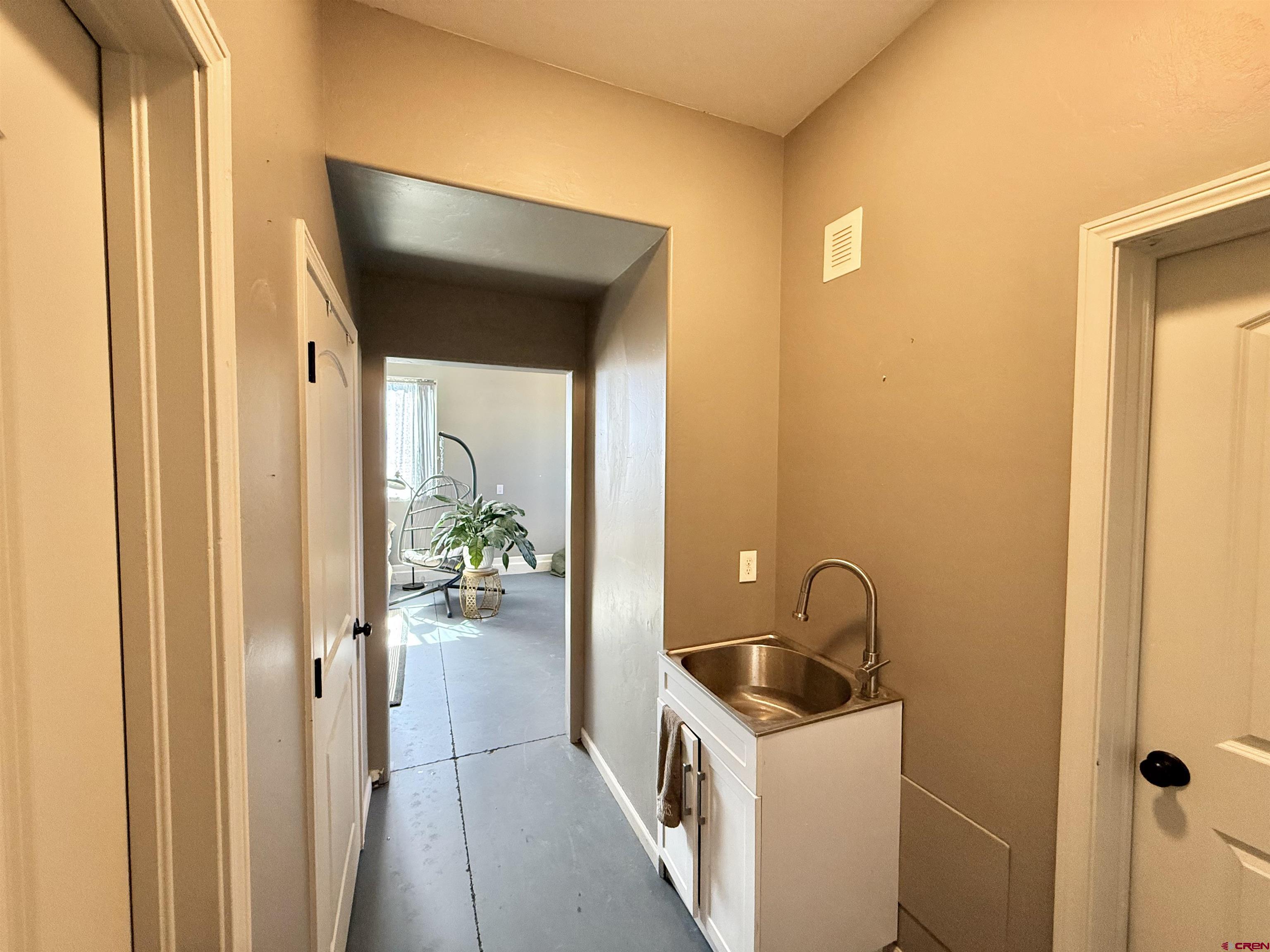 15807 5790th Road Montrose, CO 81403 - Photo 20 of 30 a hallway with a sink and dishwasher a stove with wooden floor