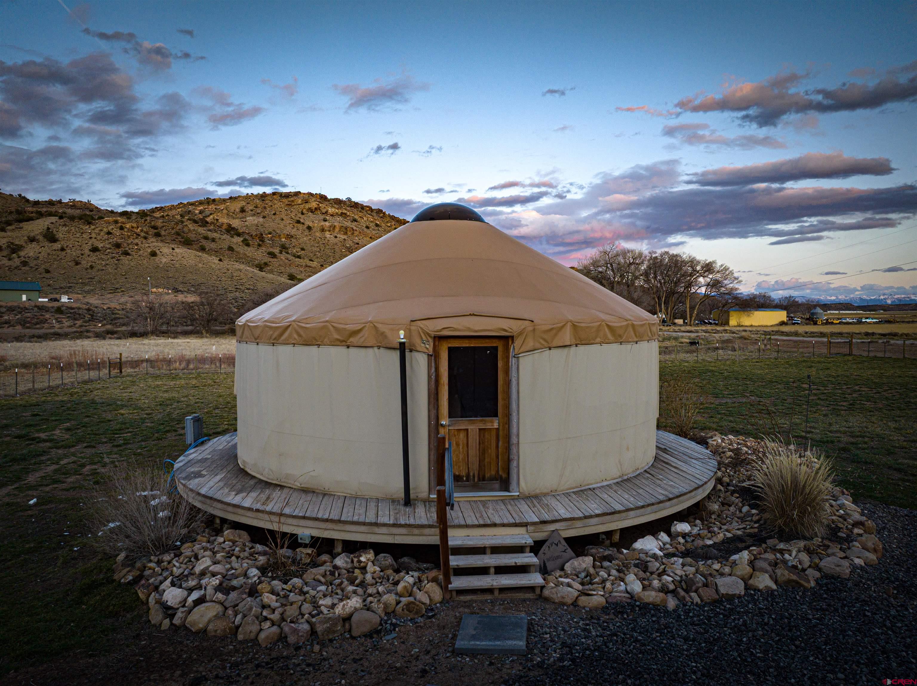 15807 5790th Road Montrose, CO 81403 - Photo 2 of 30 a view of a wooden house with a yard
