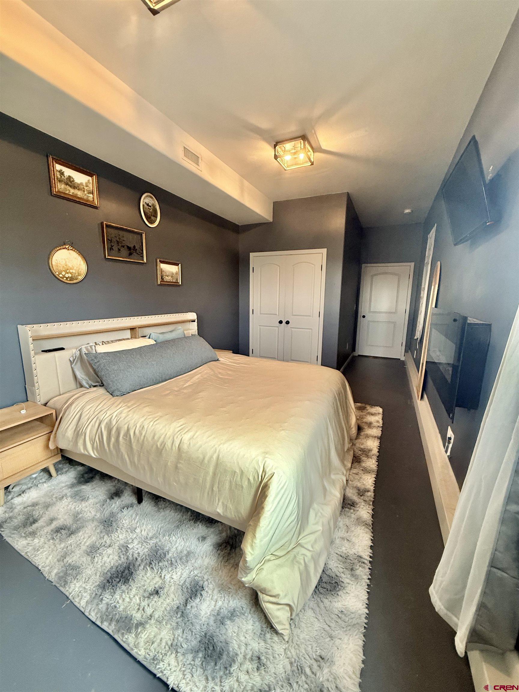 15807 5790th Road Montrose, CO 81403 - Photo 22 of 30 a bedroom with a bed and wooden floor