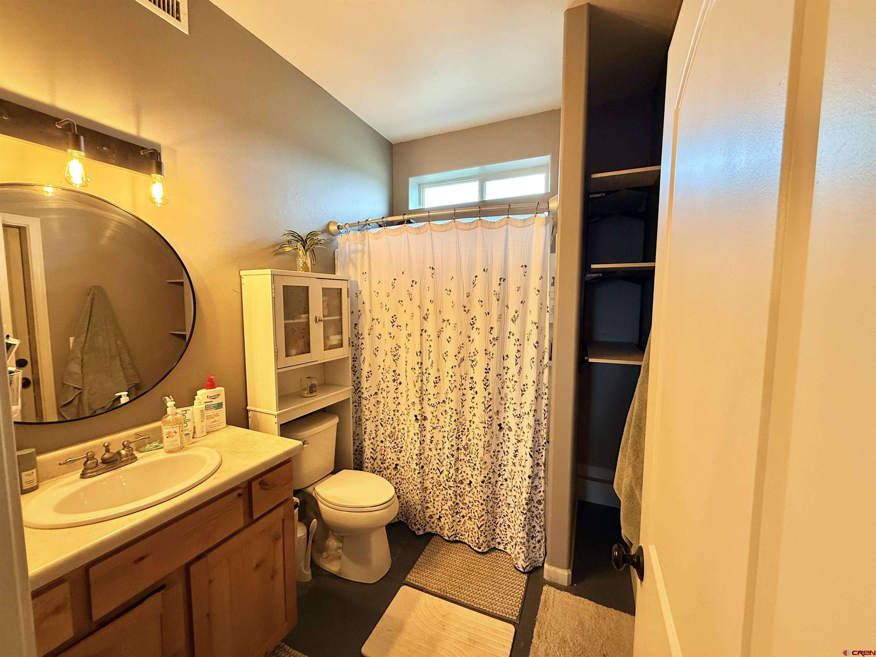15807 5790th Road Montrose, CO 81403 - Photo 23 of 30 a bathroom with a sink mirror vanity and toilet