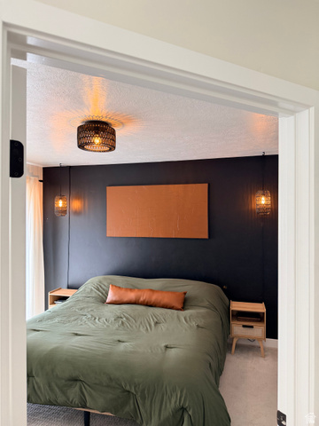 774 West 480 South American Fork, UT 84003 - Photo 76 of 76 Carpeted room featuring a dark accent wall with a wall-mounted art piece, a flush-mount ceiling light fixture, and two pendant light fixtures