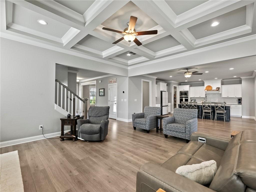 857 Champagne Lane Hoschton, GA 30548 - Photo 12 of 73 a living room with furniture and a chandelier