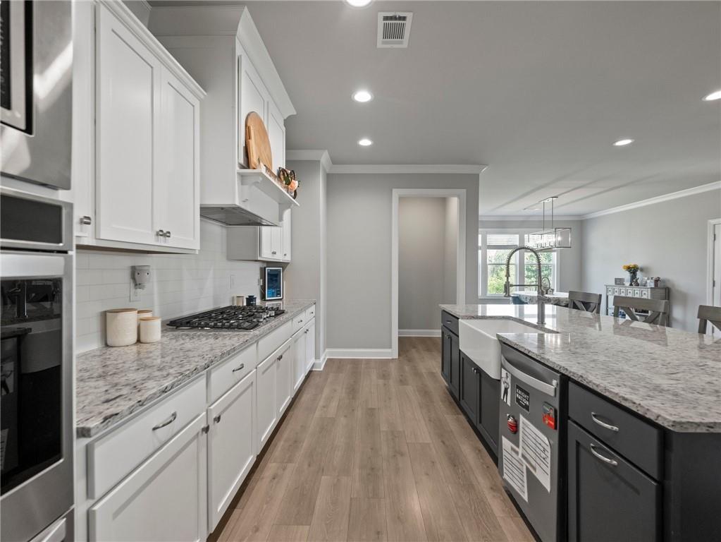 857 Champagne Lane Hoschton, GA 30548 - Photo 18 of 73 a large kitchen with granite countertop a lot of counter space