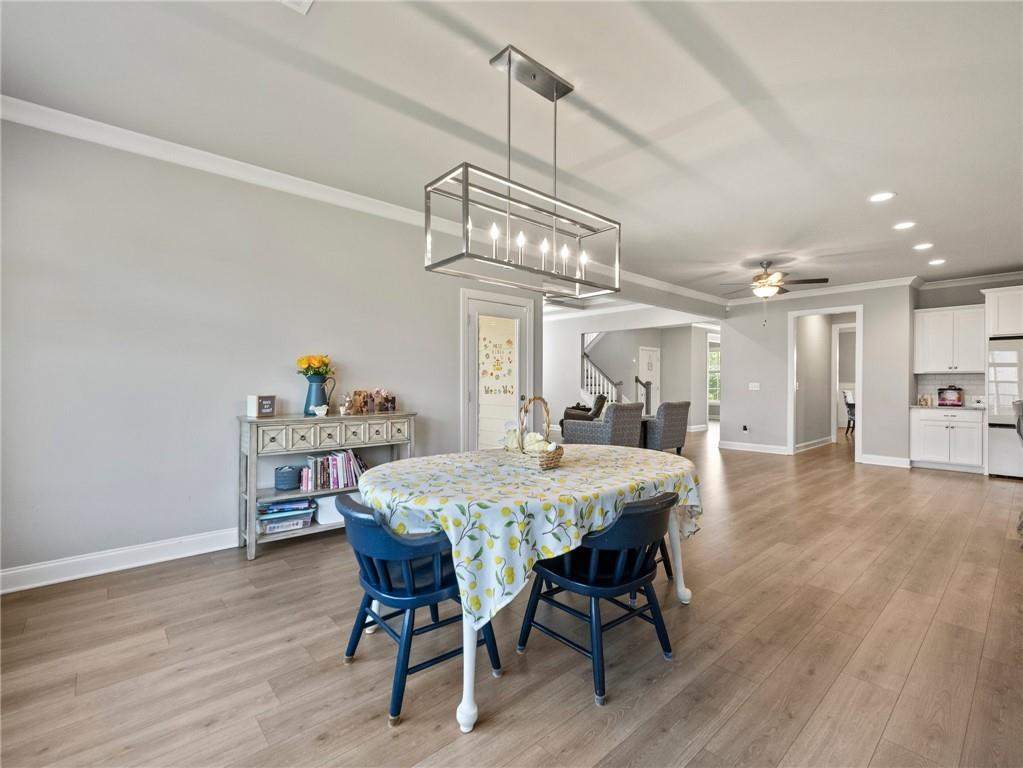 857 Champagne Lane Hoschton, GA 30548 - Photo 23 of 73 a view of a dining room with furniture and wooden floor