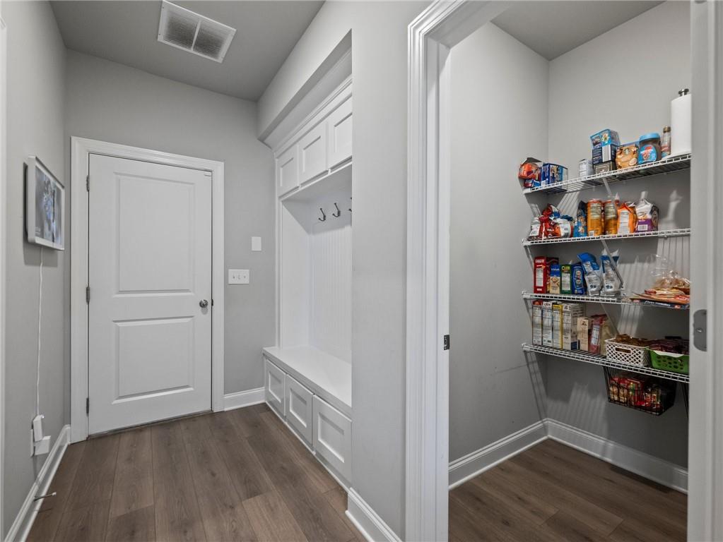 857 Champagne Lane Hoschton, GA 30548 - Photo 24 of 73 a view of walk in closet with clothes and shoes