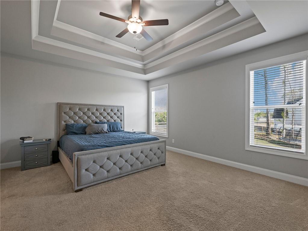 857 Champagne Lane Hoschton, GA 30548 - Photo 28 of 73 a spacious bedroom with a bed and a window