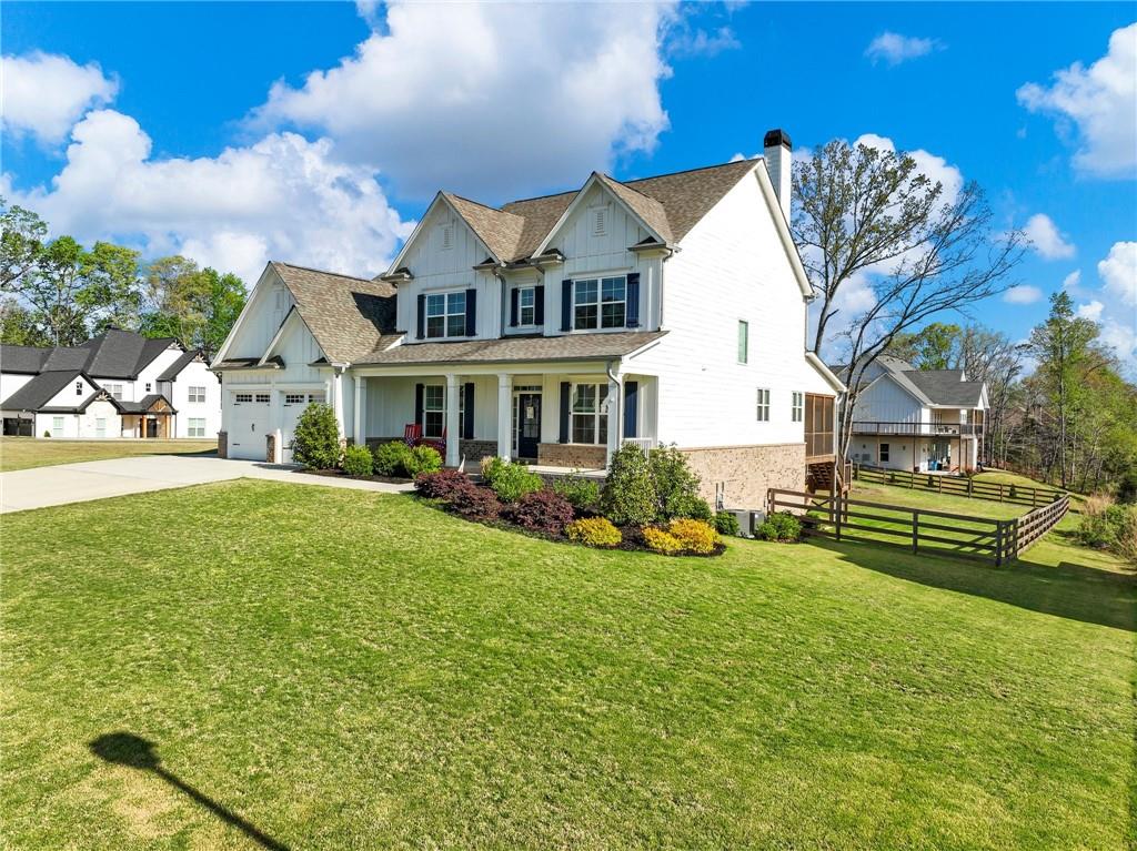 857 Champagne Lane Hoschton, GA 30548 - Photo 3 of 73 a front view of a house with a yard