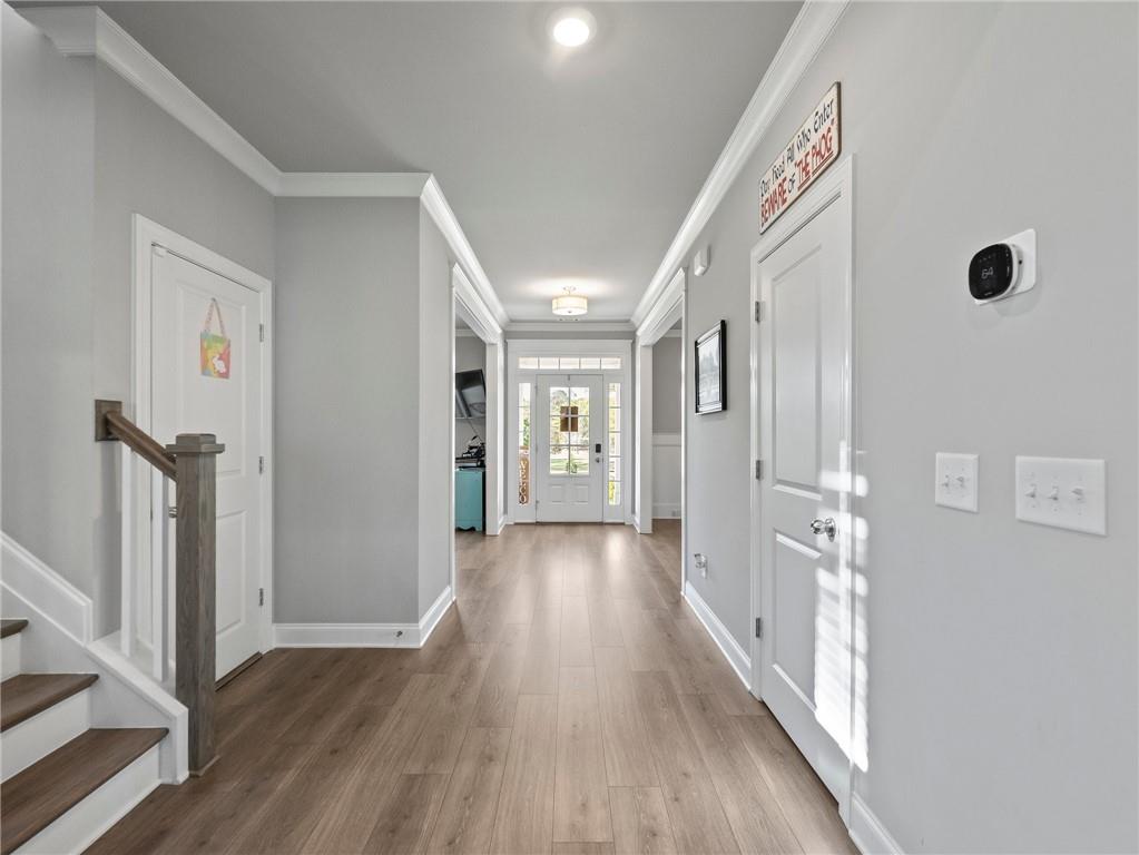 857 Champagne Lane Hoschton, GA 30548 - Photo 38 of 73 a view of a hallway with wooden floor and staircase