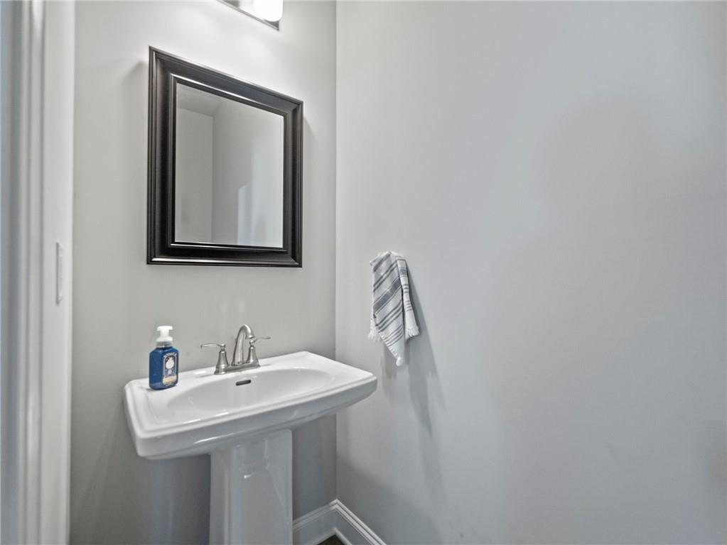857 Champagne Lane Hoschton, GA 30548 - Photo 39 of 73 a bathroom with a sink and a mirror
