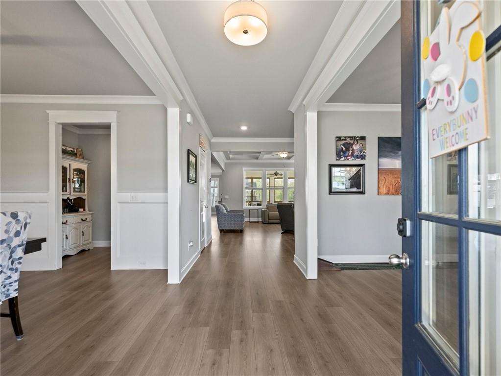 857 Champagne Lane Hoschton, GA 30548 - Photo 4 of 73 a view of a hallway view with wooden floor and dining room