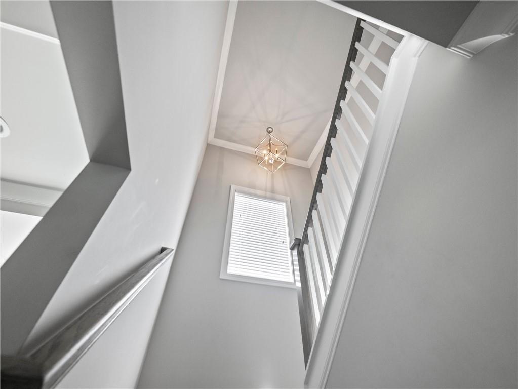 857 Champagne Lane Hoschton, GA 30548 - Photo 41 of 73 a view of staircase with white walls and railing