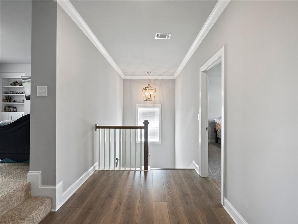 857 Champagne Lane Hoschton, GA 30548 - Photo 42 of 73 a view of a hallway with wooden floor and entryway