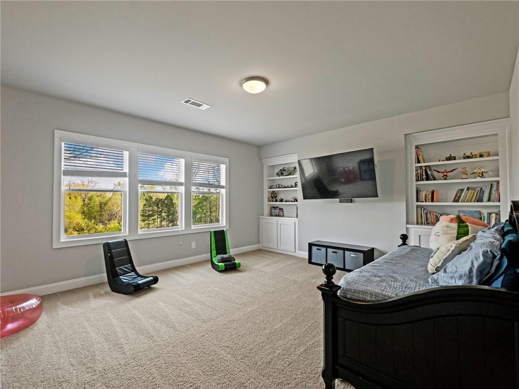 857 Champagne Lane Hoschton, GA 30548 - Photo 44 of 73 a living room with furniture and a flat screen tv