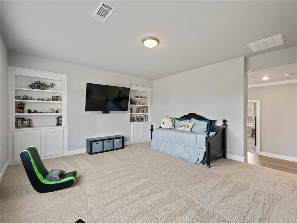 857 Champagne Lane Hoschton, GA 30548 - Photo 45 of 73 a living room with furniture and a flat screen tv