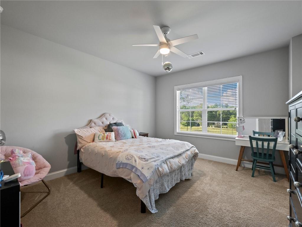 857 Champagne Lane Hoschton, GA 30548 - Photo 46 of 73 a bed room with a bed and a table