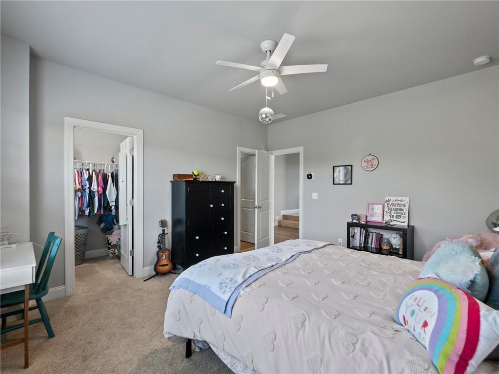 857 Champagne Lane Hoschton, GA 30548 - Photo 47 of 73 a bedroom with a bed and a chandelier