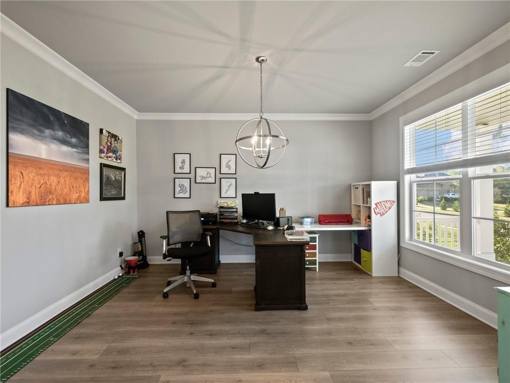 857 Champagne Lane Hoschton, GA 30548 - Photo 5 of 73 a view of a workspace with furniture and a window