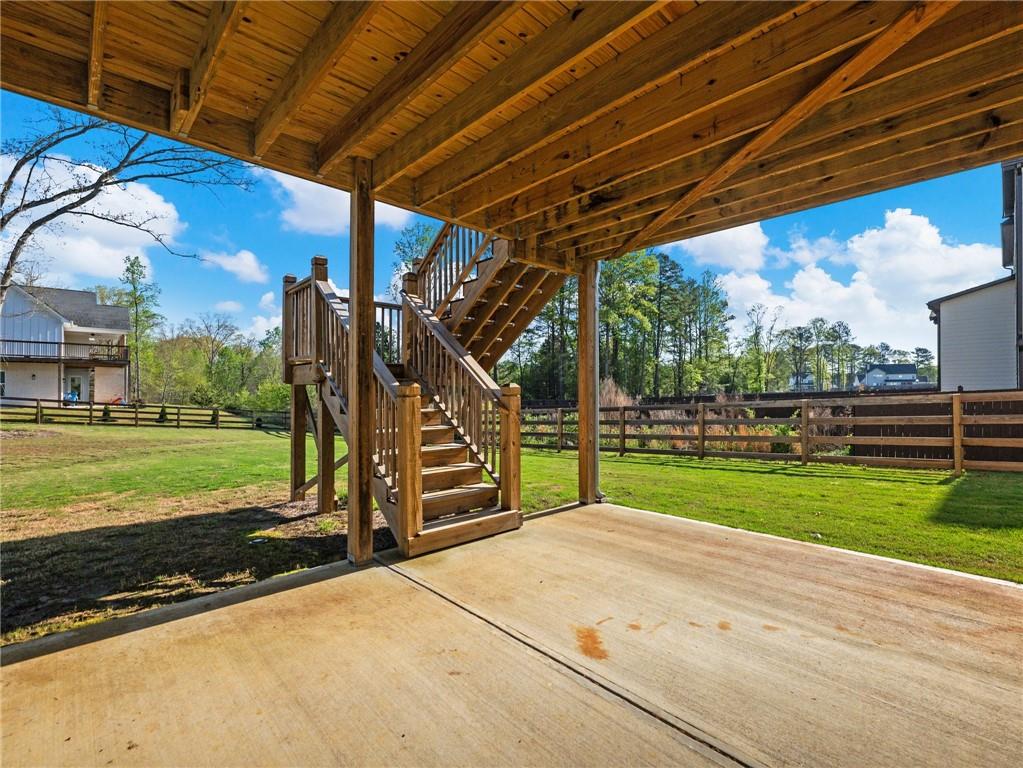 857 Champagne Lane Hoschton, GA 30548 - Photo 57 of 73 a view of a backyard with wooden floor and fence