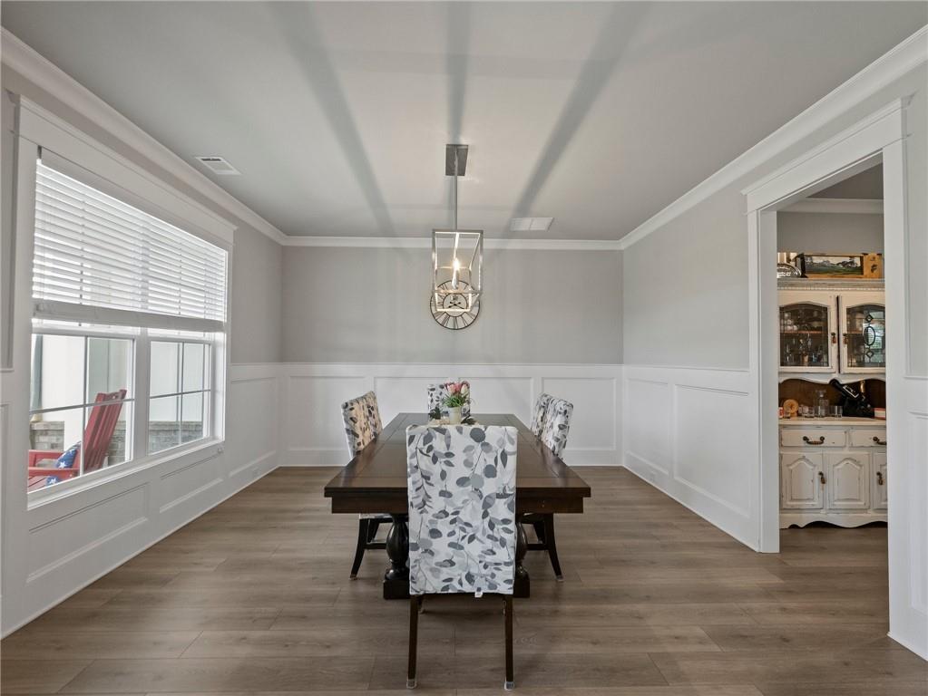 857 Champagne Lane Hoschton, GA 30548 - Photo 6 of 73 a view of a room with furniture and wooden floor