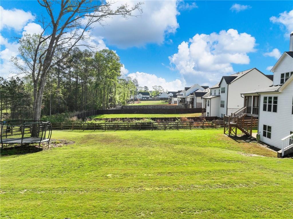857 Champagne Lane Hoschton, GA 30548 - Photo 64 of 73 a view of a swimming pool with a yard and a fountain