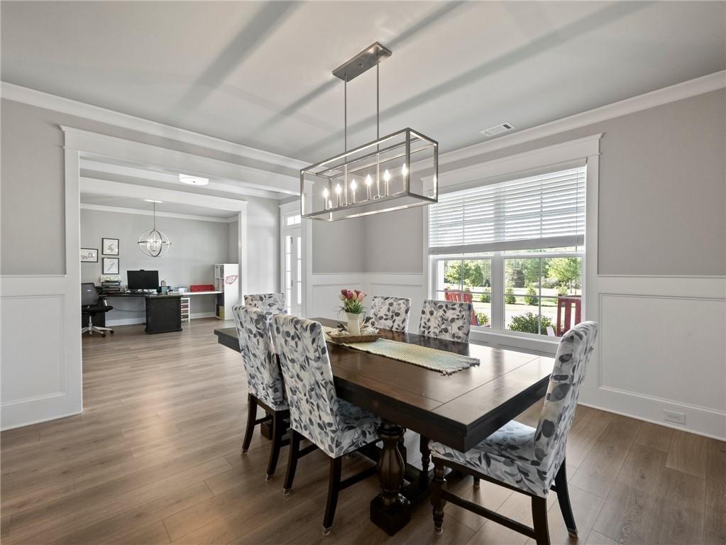 857 Champagne Lane Hoschton, GA 30548 - Photo 8 of 73 a view of a dining room with furniture window and wooden floor