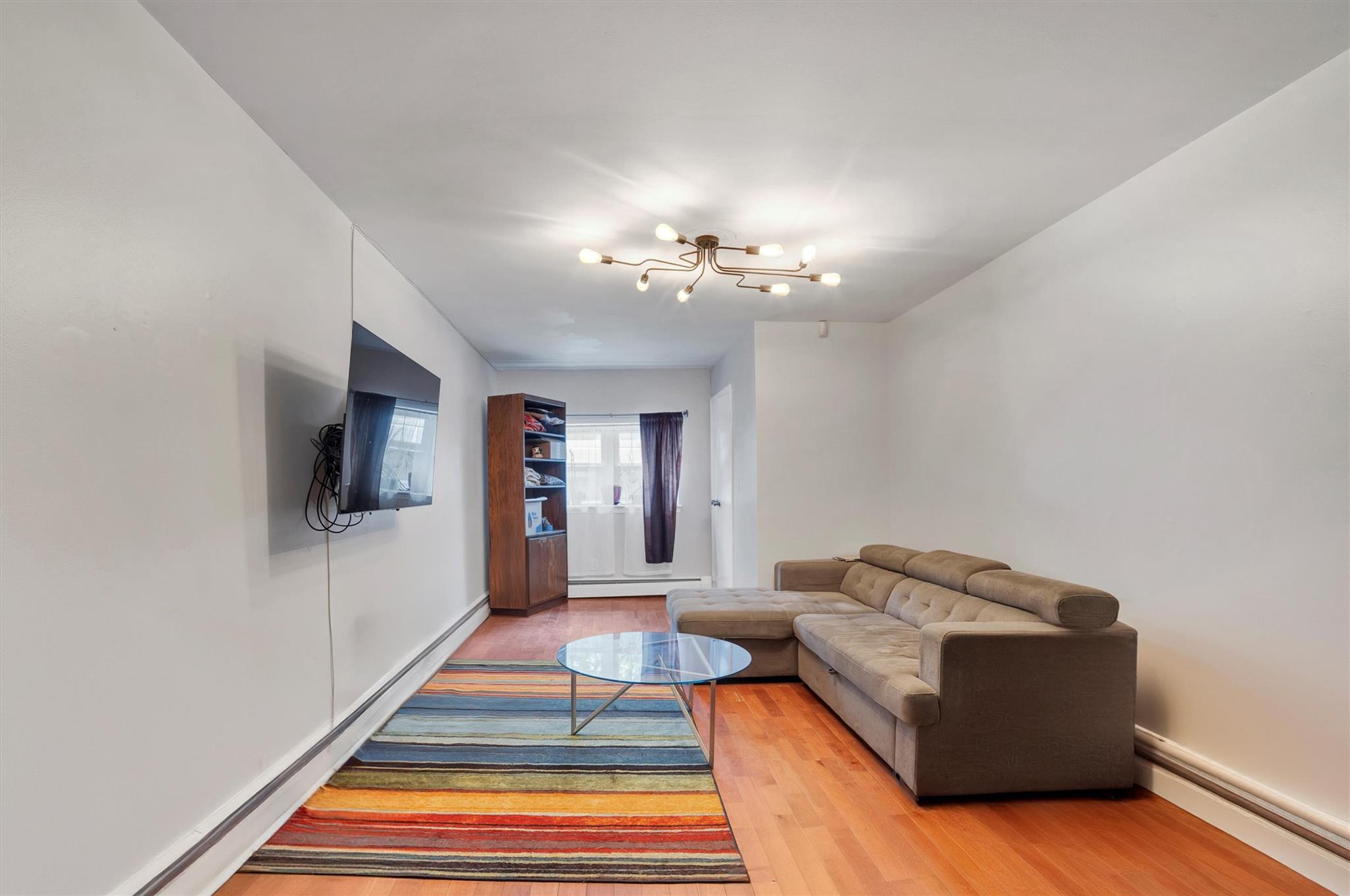 543 North Terrace Avenue Mount Vernon, NY 10552 - Photo 1 of 37 Living room featuring wood-type flooring and a baseboard heating unit